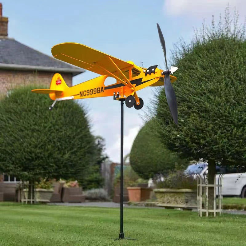 An Outdoor Garden Decorates An Airplane Weathervane